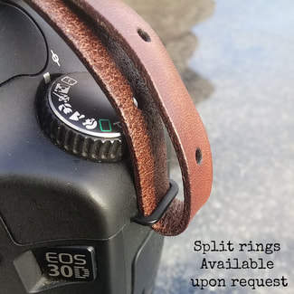 Strap connection on the side loop of a camera