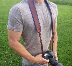 Sexy guy using camera strap